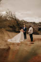 Holding hands and standing on a small rug, Andrew looks at Alison during the ceremony.